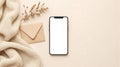 Blank screen smartphone mockup with beige envelope and dried grass Royalty Free Stock Photo