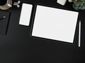 Blank screen smartphone, tablet, other supplies and copy space on dark modern worktable Royalty Free Stock Photo