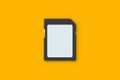 Blank SD card on orange background. SDXC memory stick Royalty Free Stock Photo