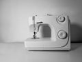 Blank sewing machine on a white table and a white wall background