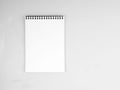 Blank sheet of notebook with a spiral on a neutral gray textured Royalty Free Stock Photo