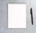 Blank sheet of notebook with a spiral on a neutral gray textured Royalty Free Stock Photo