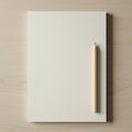 A blank sheet of off-white paper is placed centrally on a light wooden surface. A Royalty Free Stock Photo