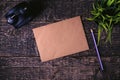 Blank sheet of old paper, alarm clock, pencil and houseplant on wooden table texture Royalty Free Stock Photo