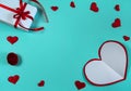 A blank sheet of paper, gift boxes, red hearts and ribbons on a light blue background. Royalty Free Stock Photo