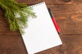 A blank sheet of paper and a pen for writing on a wooden background Royalty Free Stock Photo