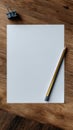 Blank Sheet of Paper and Pencil on Rustic Wooden Table Ready for Creative Writing or Sketching Ideas Royalty Free Stock Photo