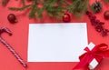 Blank sheet of paper on red background, Lollipop, gift, spruce branch, red balls, cone