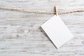 Blank sheet of white paper hanging on twine rope Royalty Free Stock Photo