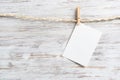 Blank sheet of white paper hanging on twine rope Royalty Free Stock Photo