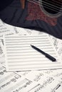 Blank sheets for notes, pen and guitar Royalty Free Stock Photo