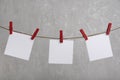 Blank sheets of paper hang with clothespins on rope. Place for your text. Copy space Royalty Free Stock Photo