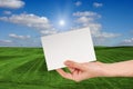 Blank Sign in Female hand Over Grass Field Royalty Free Stock Photo
