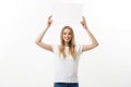 Blank sign. Woman holding empty blank white sign above her head. Excited and happy beautiful young woman isolated on Royalty Free Stock Photo