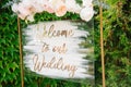 Blank signpost pointer on a wooden easel in a frame with a wreath. Welcome inscription Forest Wedding.