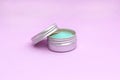 Blank silver cream jar on light pink background. Cosmetic skincare products, modern concept of organic beauty trend Royalty Free Stock Photo