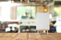 Blank small board on table in cafe, mockup for menu design