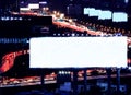 Blank space billboard at night with city traffic and car light as background, ready for advertisement Royalty Free Stock Photo