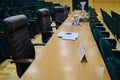 Blank space for the jury of the contest. Long jury table. Places for judges with bouquets of flowers