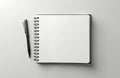 Blank spiral bound notebook with black pen. Clean pages ready for writing notes or sketching ideas. Ideal for office or school Royalty Free Stock Photo