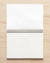 Blank spiral bound notepad mockup template on wood background Royalty Free Stock Photo
