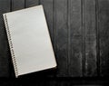 Blank spiral note pad, lined paper on rugged black background. Royalty Free Stock Photo