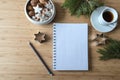 Blank spiral notebook on a home office desk with coffee cup, cookies and fir branches, concept for new year`s goals and Royalty Free Stock Photo