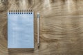 Blank spiral notebook pencil on wooden board top view Royalty Free Stock Photo