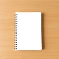 Blank spiral notebook rests on wooden surface Royalty Free Stock Photo
