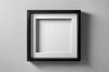 Blank square black frame with white mat board casting shadow on wall Royalty Free Stock Photo