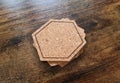 Blank stack coaster mockup with cork texture on wooden surface. Hexagonal drink pad pile template Royalty Free Stock Photo