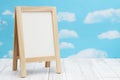 Blank standing whiteboard on weathered wood with clear sky Royalty Free Stock Photo
