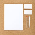 Blank Stationery on cork board. Consist of Business cards, A4 letterheads, pen and pencil. Royalty Free Stock Photo