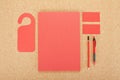 Blank Stationery on cork board. Consist of Business cards, A4 letterheads, pen and pencil.