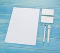 Blank Stationery on wooden background. Consist of Business cards, A4 letterheads, pen and pencil.