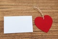 Blank sticky note with a red heart on a wooden background Royalty Free Stock Photo