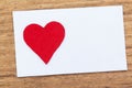 Blank sticky note with a red heart on a wooden background Royalty Free Stock Photo