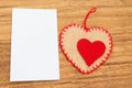 Blank sticky note with a red heart on a wooden background Royalty Free Stock Photo