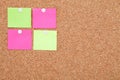 Blank sticky notes pinned on cork memo board