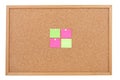 Blank sticky notes pinned on cork memo board