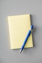 Blank sticky paper notepad and pen on gray table Royalty Free Stock Photo