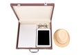 Blank tablet, laptop glasses and hat in briefcase