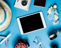 Blank tablet surrounded by travel objects Royalty Free Stock Photo