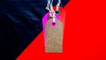 Blank tag for show price or discount on a red and black diagonal background separated. Price tags, cardboard tags in brown, purple Royalty Free Stock Photo