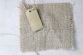 Blank tag tied with natural material string. Price tag, gift tag, sale tag, address label on Brown coarse. Royalty Free Stock Photo