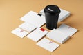 Blank takeaway coffee cup and white businesscards