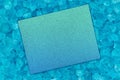 Blank teal greeting card on beach glass background