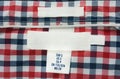 Blank texture label on red, blue and white plaid shirt Royalty Free Stock Photo