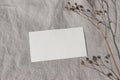 Blank textured business card mockup with dry grass, plant in sunlight. Beige linen background, sunlight, shadow overlay