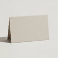 A blank, textured card stands upright in a tent shape on a plain background. The card is off-white, Royalty Free Stock Photo